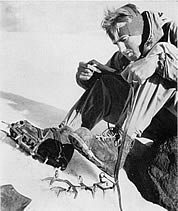 Dee Molenaar strapping on crampons. Photo by Bob and Ira Spring.