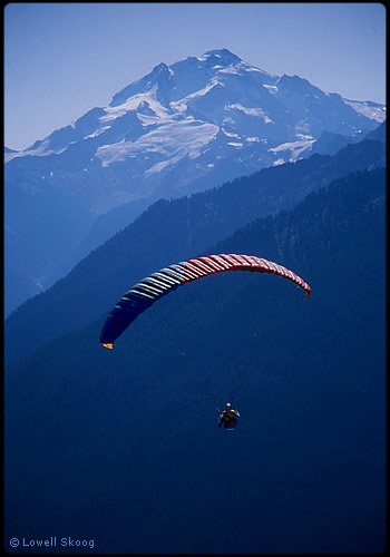 Dave Kruglinski flies from Green Mountain, Glacier Peak behind. Photo © Lowell Skoog