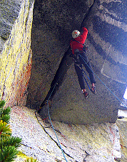 Sol Wertkin climbing the 25-ft roof on aid, Colchuck Balanced Rock. Photo &copy; Blake Herrington.