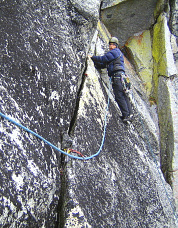 Blake Herrington leads out above the roof pitch, Colchuck Balanced Rock. Photo &copy; Sol Wertkin.