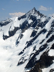 Forbidden Peak from the northwest.  The climbing route ascends the snow face and left skyline. Photo © Lowell Skoog.