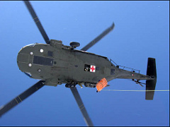 National Guard helicopter raises a critically injured victim on Mount Hood. Photo © Portland Mountain Rescue.
