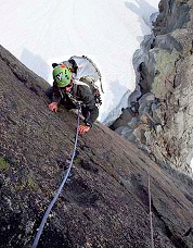 Keith Luther on the edge of the SE Face of West Challenger. Photo © Seth Pollack.