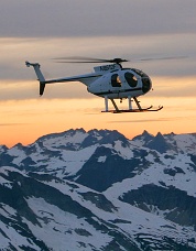 Pilot Tony Reece arrives in the helicopter at sunset. Photo &copy; Steph Abegg.
